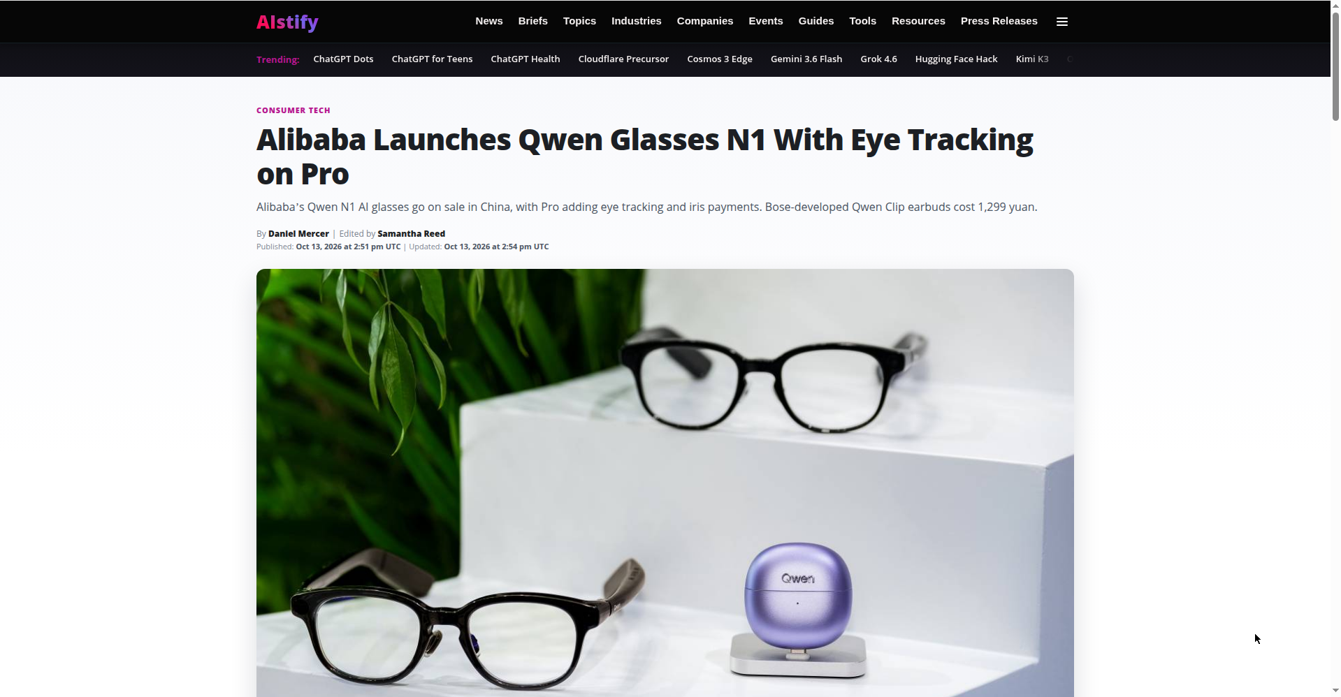 Screenshot of an AIstify news article page headlined "Alibaba Launches Qwen Glasses N1 With Eye Tracking on Pro", showing two pairs of black Qwen smart glasses and a purple Qwen Clip earbuds case on a white display stand.
